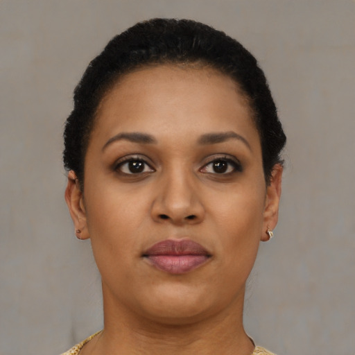 Joyful black young-adult female with short  brown hair and brown eyes