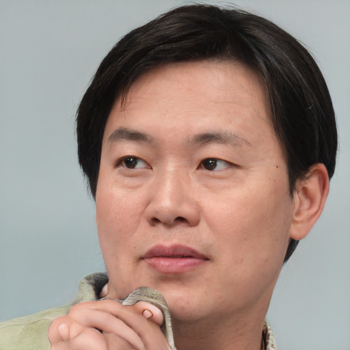 Neutral asian adult male with short  brown hair and brown eyes