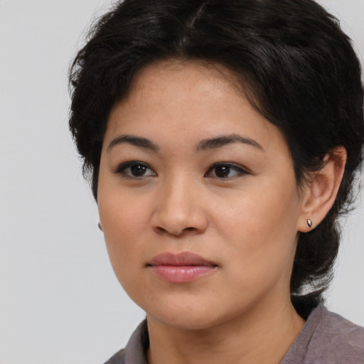Joyful white young-adult female with medium  black hair and brown eyes