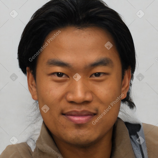 Joyful asian young-adult male with short  black hair and brown eyes