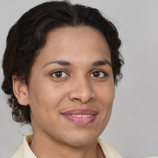 Joyful latino adult female with short  brown hair and brown eyes