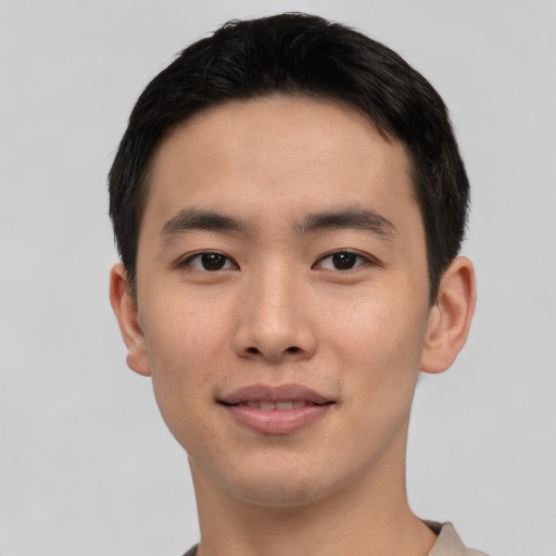 Joyful asian young-adult male with short  black hair and brown eyes