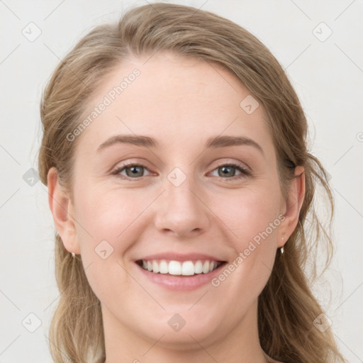 Joyful white young-adult female with long  brown hair and blue eyes