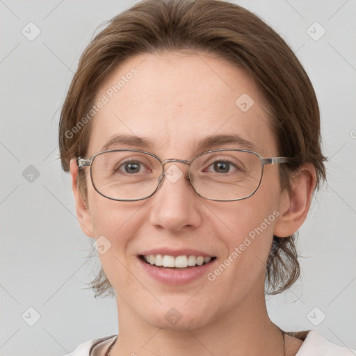 Joyful white adult female with medium  brown hair and grey eyes