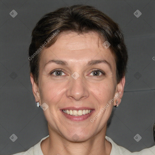 Joyful white adult female with short  brown hair and grey eyes