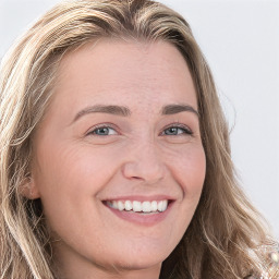 Joyful white young-adult female with long  brown hair and blue eyes