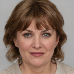 Joyful white adult female with medium  brown hair and grey eyes