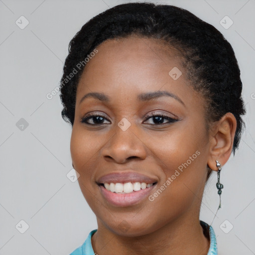 Joyful black young-adult female with long  black hair and brown eyes