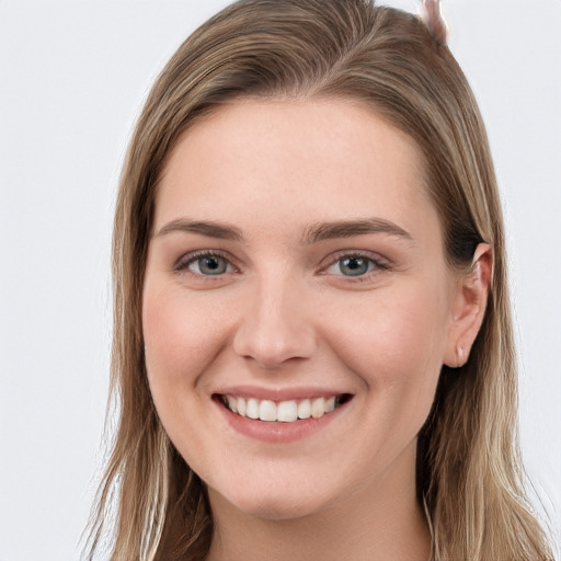 Joyful white young-adult female with long  brown hair and grey eyes