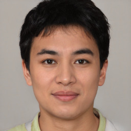 Joyful asian young-adult male with short  brown hair and brown eyes