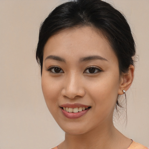 Joyful asian young-adult female with medium  brown hair and brown eyes