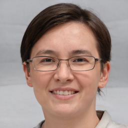 Joyful white adult female with short  brown hair and grey eyes