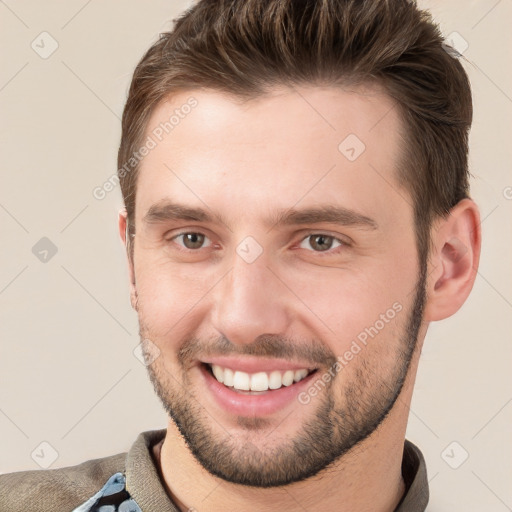 Joyful white young-adult male with short  brown hair and brown eyes