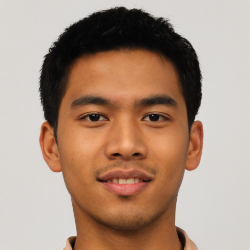 Joyful asian young-adult male with short  brown hair and brown eyes