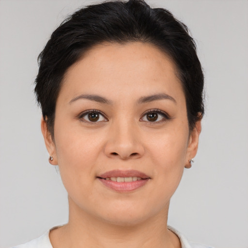 Joyful asian young-adult female with short  brown hair and brown eyes