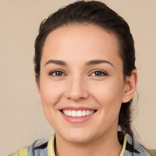 Joyful white young-adult female with medium  brown hair and brown eyes