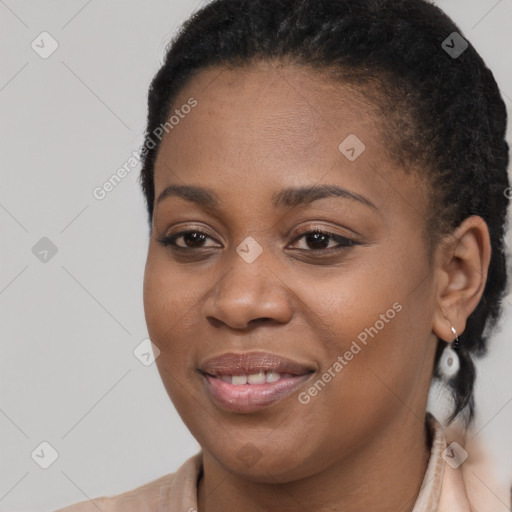 Joyful black young-adult female with long  brown hair and brown eyes