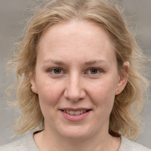 Joyful white young-adult female with medium  brown hair and blue eyes