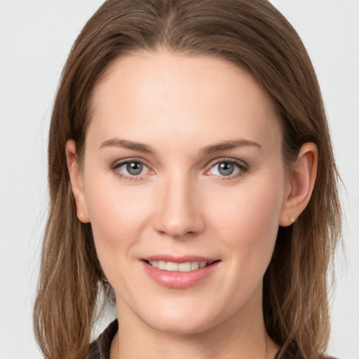 Joyful white young-adult female with long  brown hair and grey eyes