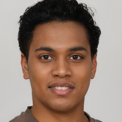 Joyful latino young-adult male with short  brown hair and brown eyes