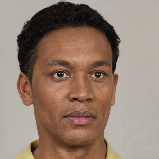 Neutral latino adult male with short  black hair and brown eyes