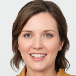 Joyful white young-adult female with medium  brown hair and blue eyes