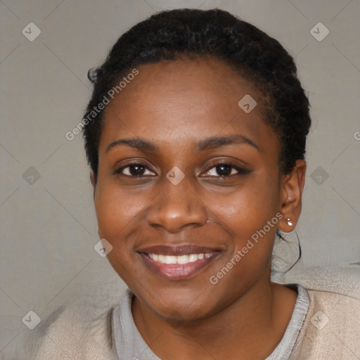 Joyful black young-adult female with short  black hair and brown eyes