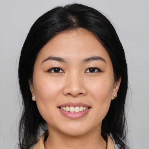 Joyful asian young-adult female with medium  brown hair and brown eyes