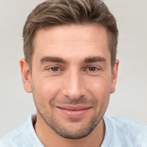 Joyful white young-adult male with short  brown hair and brown eyes