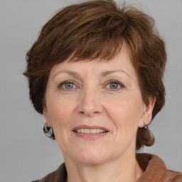 Joyful white adult female with medium  brown hair and grey eyes