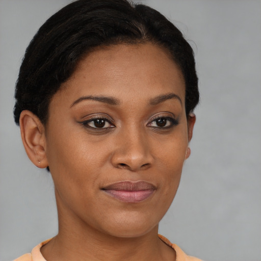 Joyful black young-adult female with short  brown hair and brown eyes