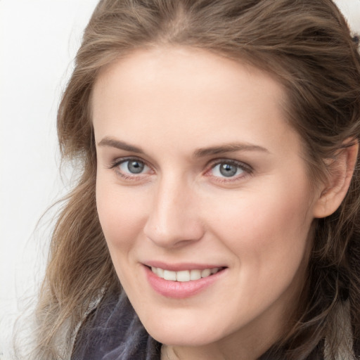 Joyful white young-adult female with long  brown hair and blue eyes