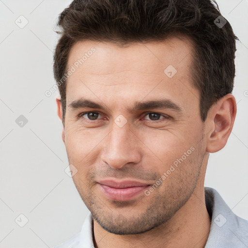 Joyful white young-adult male with short  brown hair and brown eyes