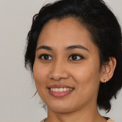 Joyful latino young-adult female with medium  black hair and brown eyes