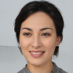 Joyful asian young-adult female with medium  brown hair and brown eyes