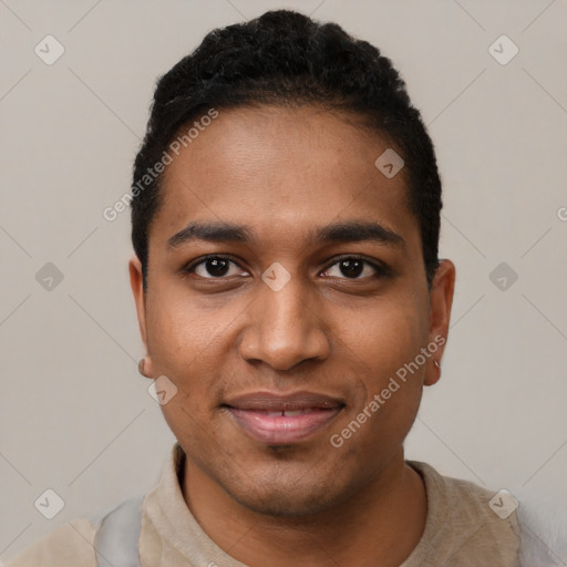 Joyful black young-adult male with short  black hair and brown eyes