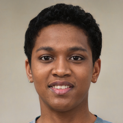 Joyful black young-adult female with short  black hair and brown eyes