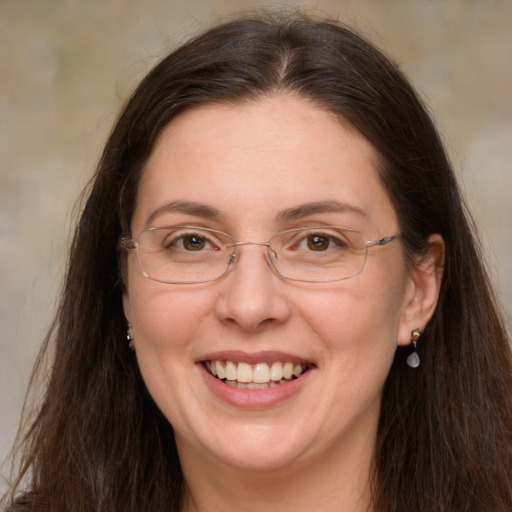 Joyful white adult female with long  brown hair and grey eyes