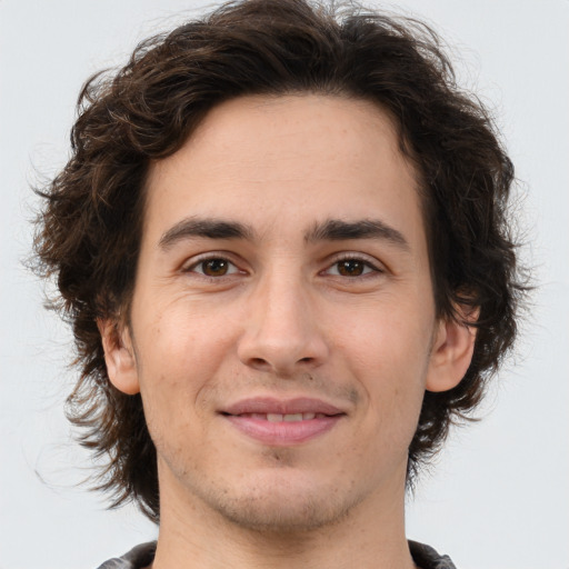 Joyful white young-adult male with medium  brown hair and brown eyes