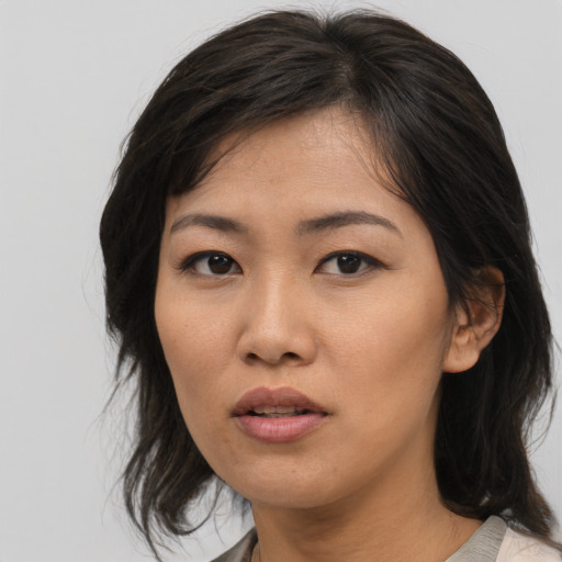 Neutral asian young-adult female with medium  brown hair and brown eyes