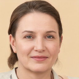 Joyful white young-adult female with medium  brown hair and grey eyes