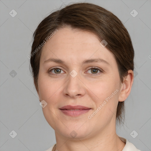 Joyful white adult female with medium  brown hair and grey eyes