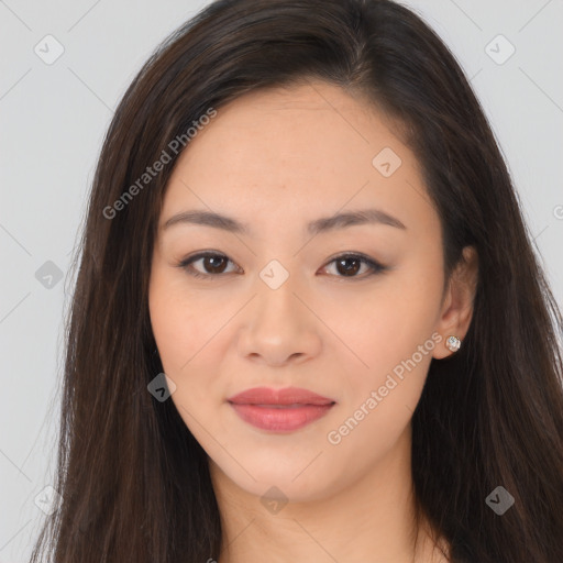 Joyful asian young-adult female with long  brown hair and brown eyes