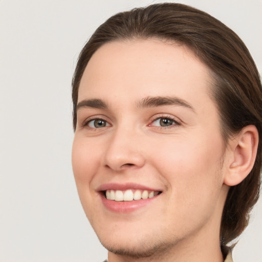 Joyful white young-adult female with medium  brown hair and grey eyes