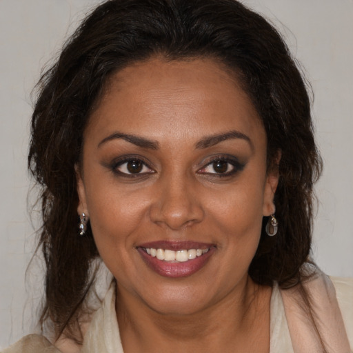 Joyful black young-adult female with medium  brown hair and brown eyes