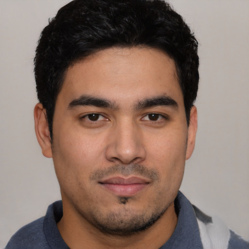 Joyful asian young-adult male with short  black hair and brown eyes