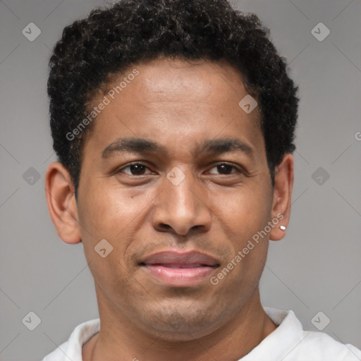 Joyful latino young-adult male with short  brown hair and brown eyes