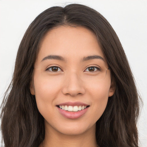 Joyful white young-adult female with long  brown hair and brown eyes