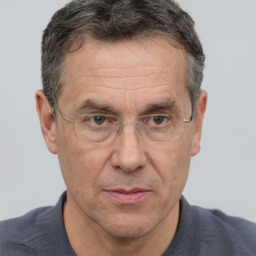 Joyful white middle-aged male with short  brown hair and brown eyes