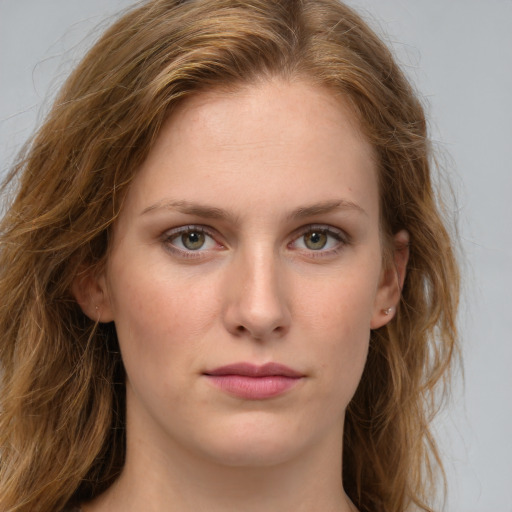 Joyful white young-adult female with long  brown hair and green eyes